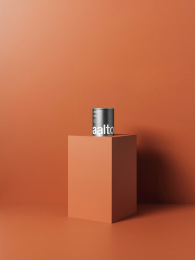 Aalto paint tin sitting on a plinth with an orange painted backdrop
